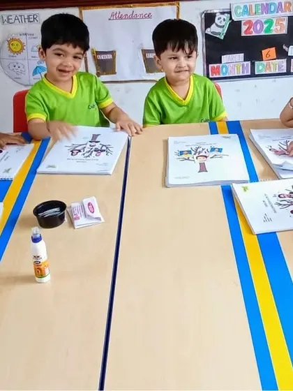 A happy classroom scene where children are working on a craft project. Group activities like this foster a sense of community and allow kids to learn from each other.