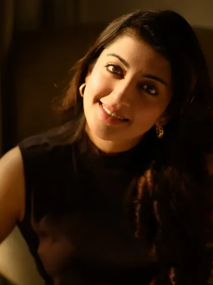 A smiling portrait of Pranitha, where the natural light fills the room. This kind of image feels warm, authentic, and full of life.