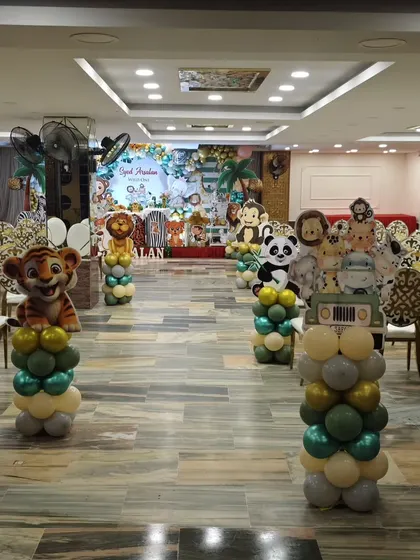 A view from the guest's perspective, showing the aisle decorated with animal balloon pillars leading to the main stage.