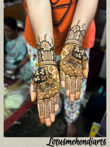 A stunning guest mehendi with lotus cuffs and intricate patterns on the palm. This design has the feel of a bridal mehendi.