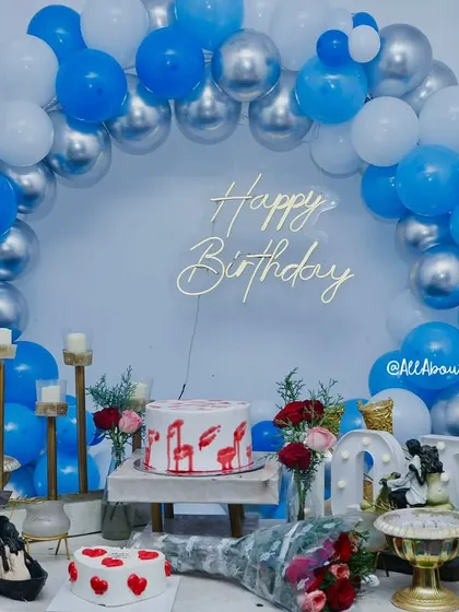 The 'Smokey Lounge' setup without the smoke effect, showing the beautiful arrangement of blue, silver, and white balloons, cakes, and floral details.