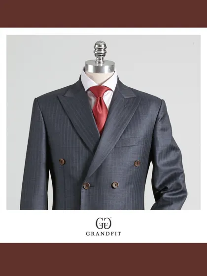 A detailed view of the grey double-breasted jacket, focusing on the subtle texture of the fabric and the precision of the lapel construction.