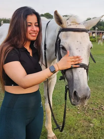A gentle pat and a happy smile. We encourage our riders to spend time bonding with their horses.