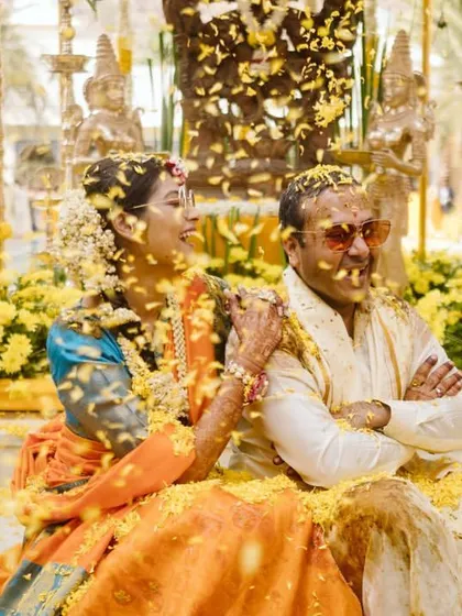 Another angle of the flower shower, capturing the couple's happy expressions as they are covered in petals.