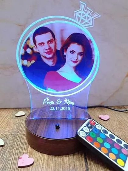 This custom LED photo lamp is a perfect gift for anniversaries or birthdays. I can engrave your names and a special date below your favorite photo, and you can change the light color with the included remote to match any mood.