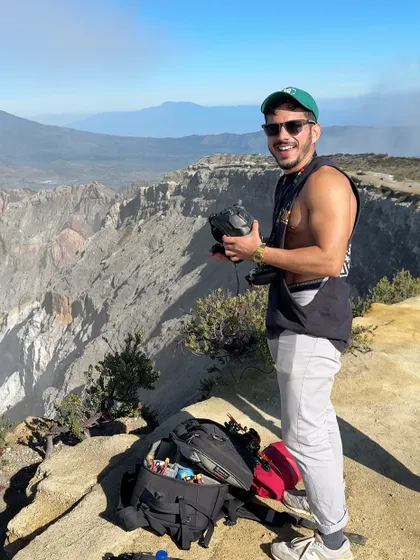 On the edge of a massive crater, preparing my gear for a flight. This behind-the-scenes shot captures the scale of the locations FPV takes me to.