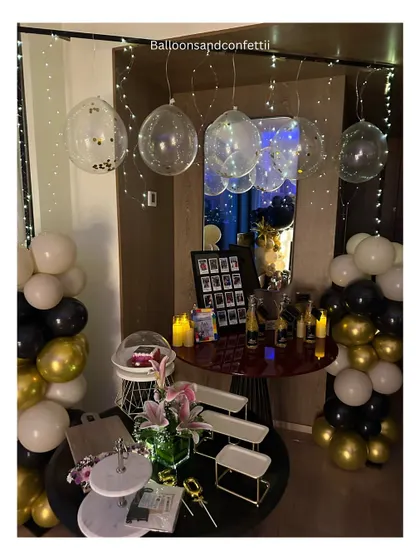 The full dessert and drinks corner for the 50th birthday celebration, with fairy-light bubble balloons and personalized party favors.