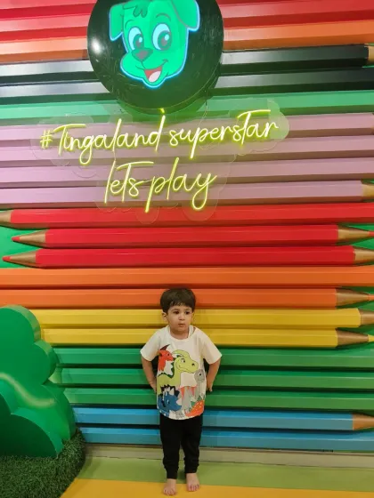 A young superstar strikes a pose in front of our colorful pencil wall. This is one of our most iconic and Instagrammable spots.