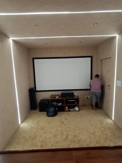 A shot during the setup process, showing the clean lines of the integrated LED lighting that frames the room.