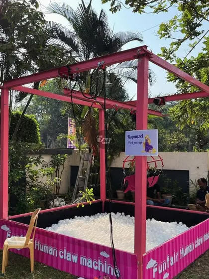 A 'Human Claw Machine' filled with balls was one of the many funfair games set up for the kids to play.