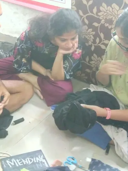 Our textile mending sessions are relaxed and collaborative. Here, participants are gathered on the floor, sharing tips and learning hand-sewing techniques together. It’s a perfect example of our grassroots, community-first approach to repair.