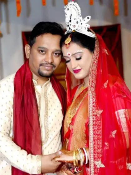 My beautiful Bengali bride with her husband. I created a traditional look for her with classic winged eyeliner, a red bindi, and a bold lip to complement her red saree.