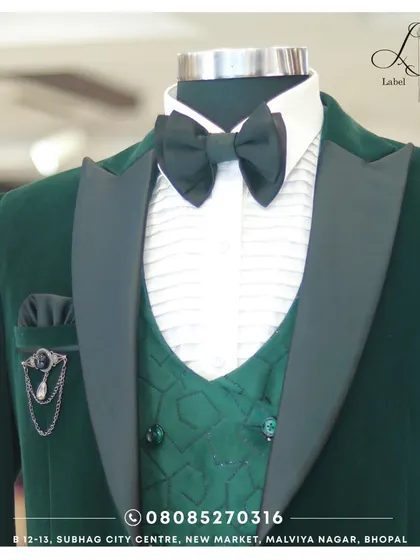 This deep green velvet tuxedo is the definition of luxury. The matching patterned waistcoat, satin lapels, and elegant brooch create a rich, textured look that's perfect for a winter wedding or gala.
