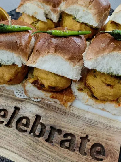 Celebrate any occasion with a platter of our delicious mini Vada Pav, served on a wooden board to highlight the festive mood.