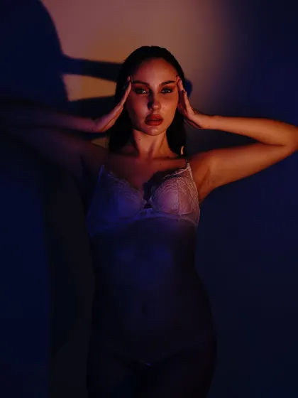 A slight variation of the previous pose, with the model looking directly at the camera, creating a powerful and engaging connection.