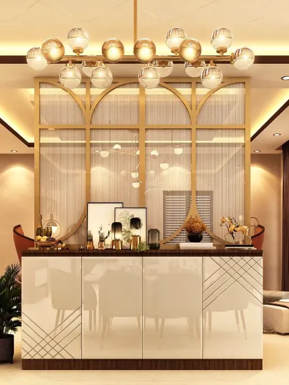 This elegant partition separates the dining area while maintaining an open feel. The design features a glossy white crockery cabinet below a gold-finished frame with sheer curtains, blending privacy with glamour.