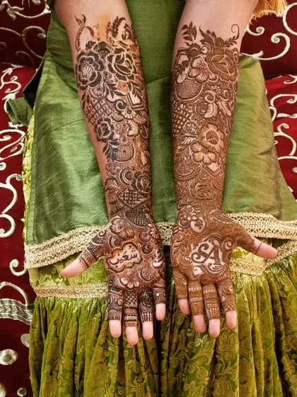 My pretty bride is all set for her wedding with this personalized floral henna. We included her and her partner's initials, along with their names in Arabic.