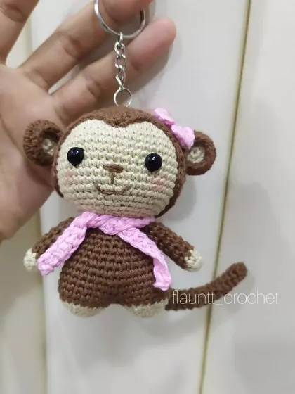 This little monkey was made as a keychain. You can see the secure ring attached. It's a great way to add a personal, handmade touch to your accessories.