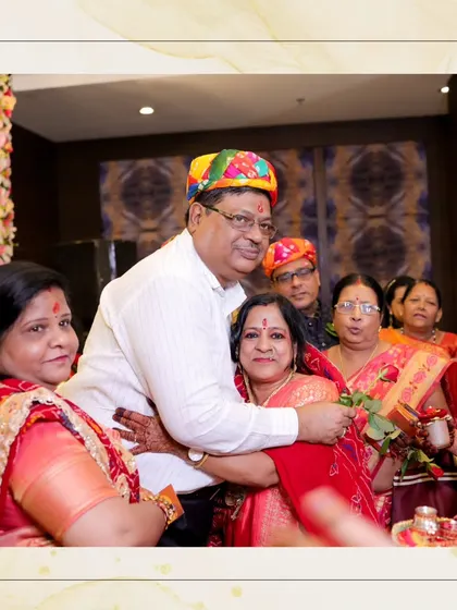 A heartwarming photo of family members hugging during a traditional ceremony. The colorful turbans and joyful expressions tell a story of love.