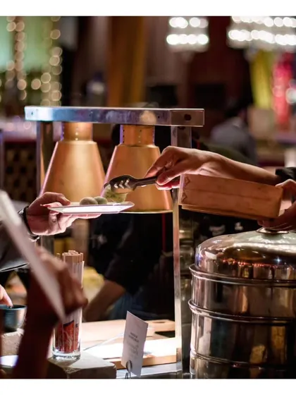 Guests being served at our live dim sum station, a popular choice for adding an authentic Pan-Asian touch to any menu.