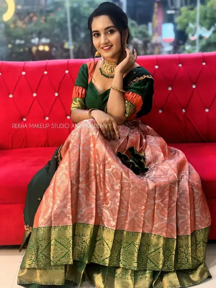 The full look of our peach and green half saree, showing its beautiful drape and vibrant colors.