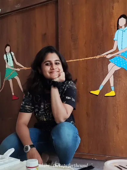 A duplicate image of me with the 'Tug of War' mural, a fun project that brought a playful spirit to a functional piece of furniture.