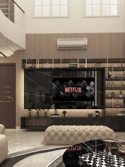 A sophisticated entertainment area within a double-height space. The black marble TV unit with integrated shelving and backlighting creates a sleek and organized focal point for media consumption.