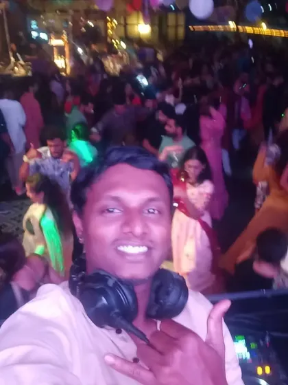A classic DJ selfie from the booth. You can see the packed dance floor in the background, which is the sign of a successful night.