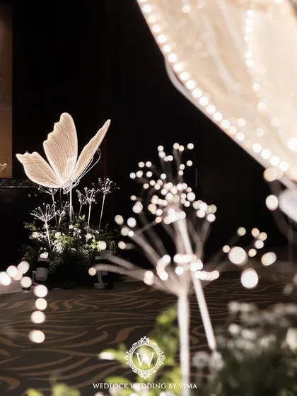 An enchanted forest Sangeet night, where the ceiling was a canopy of lush greenery dotted with sparkling disco balls and glowing LED butterflies. This immersive decor created a magical atmosphere for dancing.