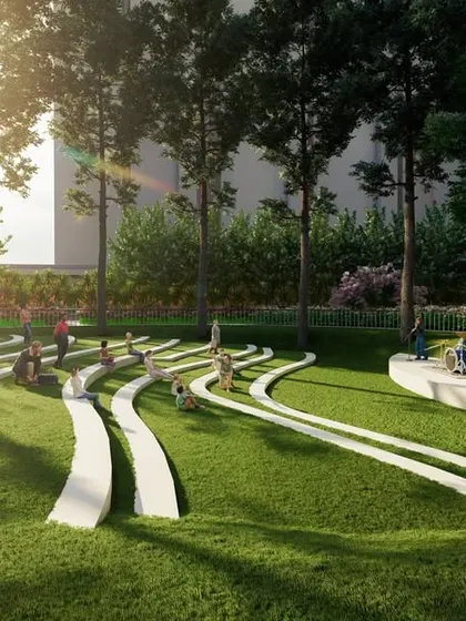 A ground-level view of the sculptural lawn, showing people using the undulating forms for sitting and relaxing in a sun-drenched park.