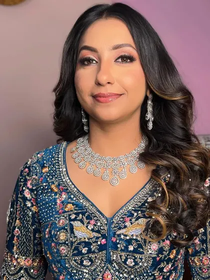 A portrait of the happy bride-to-be. Her makeup is natural yet polished, perfect for celebrating with family and friends.
