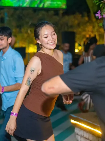 A dancer smiling as she moves across the floor. The joy of movement is evident in every step.