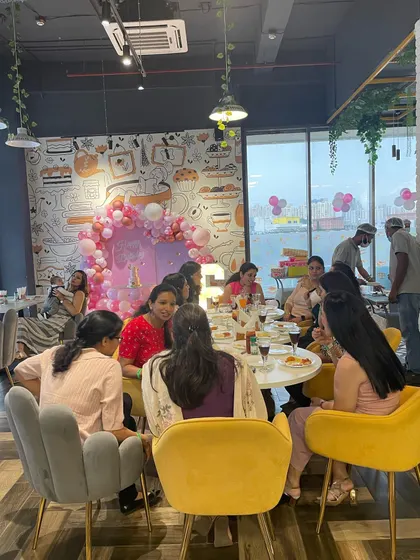 Our cafe is the perfect spot for a kitty party or a celebratory meal with friends. Here, a group of ladies enjoys a get-together while their kids are safely playing nearby.