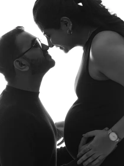 A close-up silhouette of a couple sharing an intimate moment. This black and white photo is full of love and anticipation, a beautiful and artistic memory.