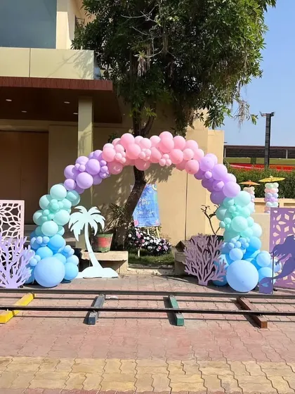 The entrance arch for the pool party, featuring a beautiful rainbow of pastel balloons.