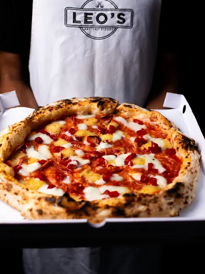 Serving pizza hot and fresh, whether you're dining in or taking it home. This one's a spicy pepperoni.