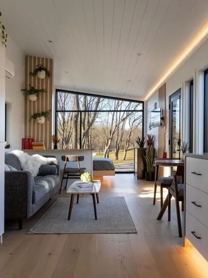 Natural light is key in my designs. This living space in a modular home uses large windows to create a bright and airy atmosphere, making the home feel spacious and connected to its surroundings.