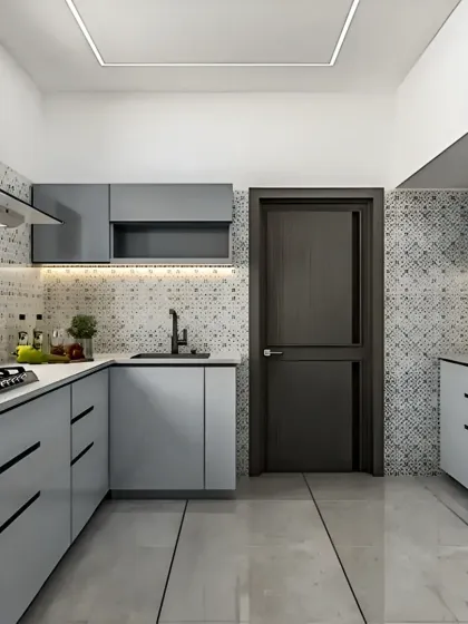 A clean and contemporary L-shaped kitchen featuring light grey handleless cabinets and a striking patterned tile backsplash. The layout is practical and spacious, with a well-defined work triangle connecting the sink, stove, and prep areas.