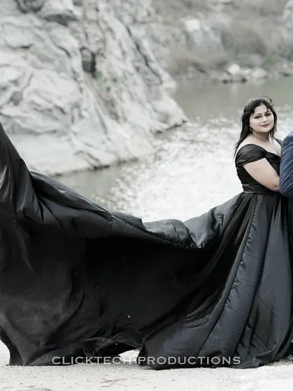 Another angle of the dramatic quarry shoot, focusing on the couple's pose and the impressive spread of the black trail gown.
