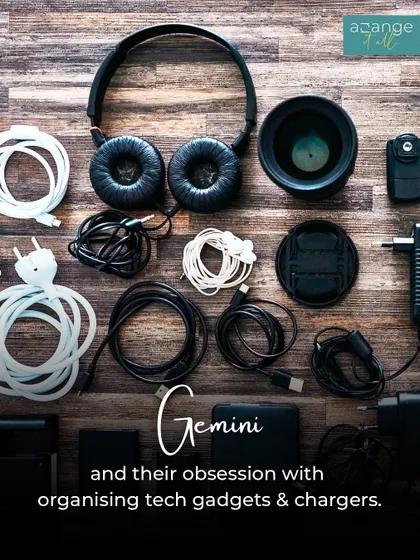 A Gemini's obsession: organizing tech gadgets and chargers. This flat lay shows a neat arrangement of cables, headphones, and power banks.