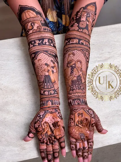 This is a storytelling mehandi at its finest, with multiple panels showing different scenes from the couple's life and wedding ceremonies. Each part of the design has a special meaning.