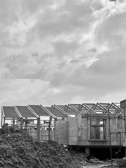 "Roof Likes To Swing": A series of black and white photos tracking the progress of a large-scale steel roof structure for an experience center in Chennai.