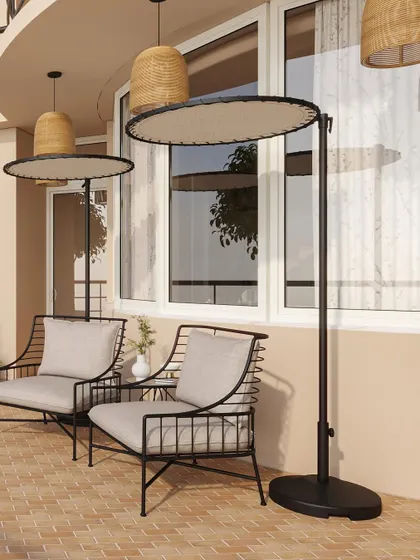 Modern outdoor lounge chairs are paired with unique standing shades, providing comfort and style for sunny afternoons.