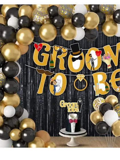 A "Groom to be" party setup with a black, gold, and white balloon theme. This decoration includes a fun banner and a themed cake topper for the celebration.