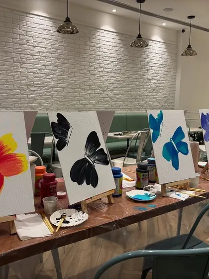 The finished butterfly paintings from our late-night workshop. It's so cool to see how everyone brings their own style to the same theme, creating a diverse and beautiful collection of art.