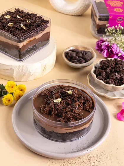 A decadent chocolate tub dessert styled for Raksha Bandhan, with deconstructed ingredients to showcase its rich texture.