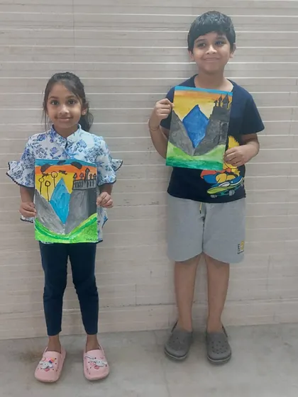 Two students proudly holding up their Hogwarts castle paintings. It's so rewarding to see their love for a story translate into beautiful art.