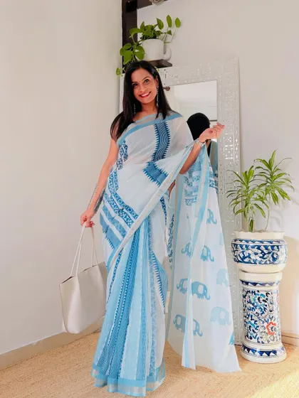 A beautiful white and blue linen saree with an elephant motif print. It's a playful and chic design that is perfect for a casual day out.