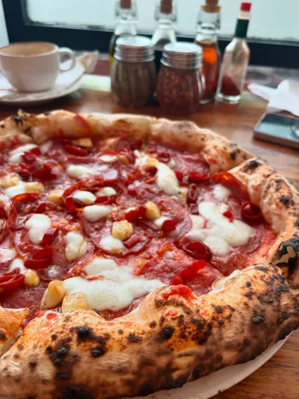 A spicy pepperoni pizza, waiting to be devoured. It's one of our most popular choices.