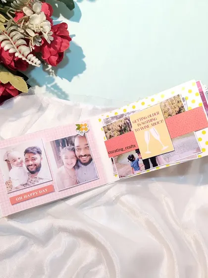 An inside page of the husband's birthday mini scrapbook, filled with family photos.